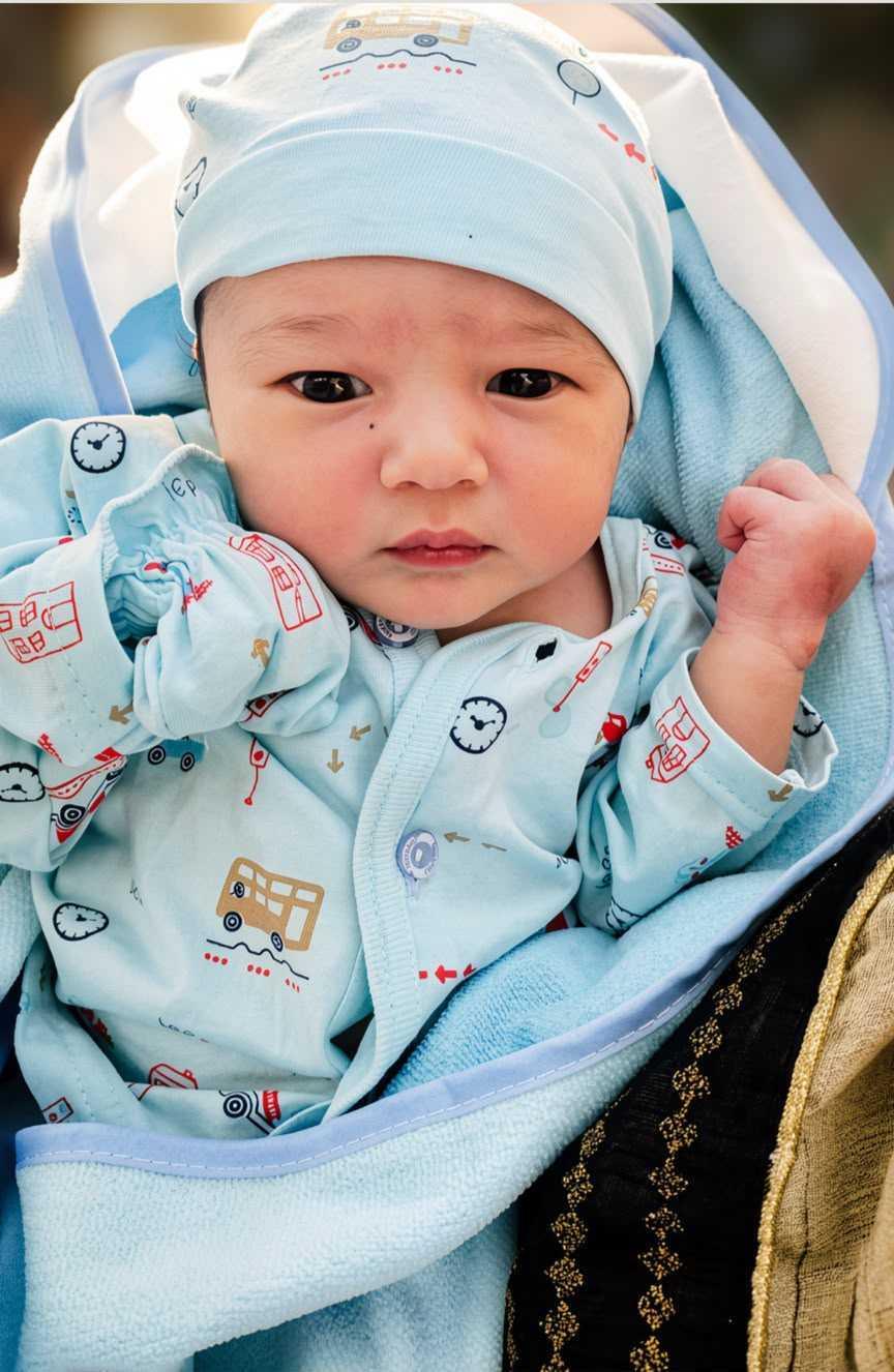 Newborn baby in a blue outfit